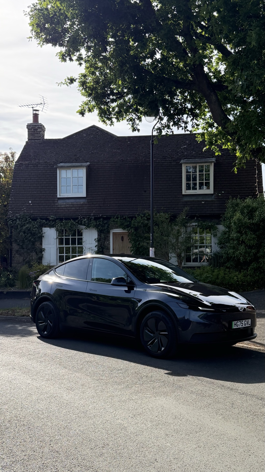 Model Y RWD parked outside a village cottage
