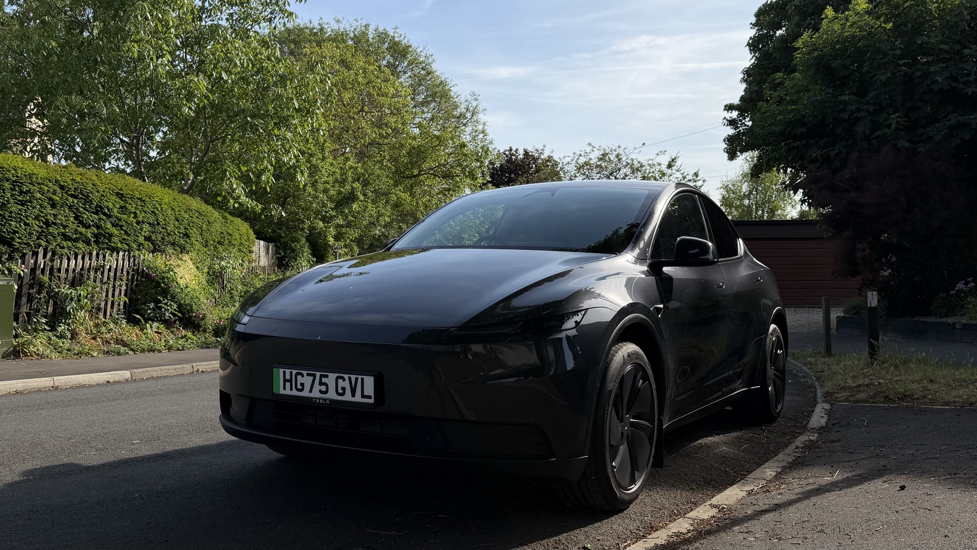 Side profile of the Model Y RWD on a quiet road