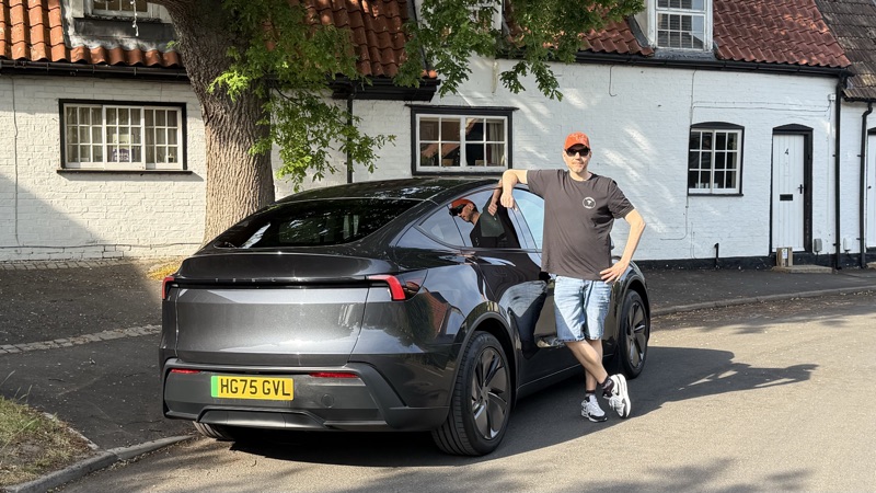 Standing next to the Model Y RWD in a village setting
