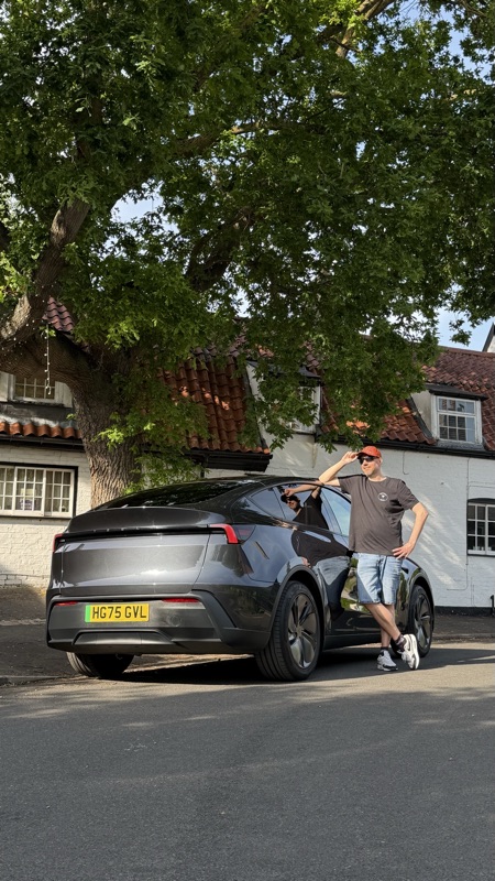 Posing with the Model Y RWD, rear three-quarter