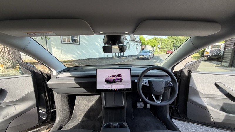 Dashboard and screen showing pink Model 3 on display