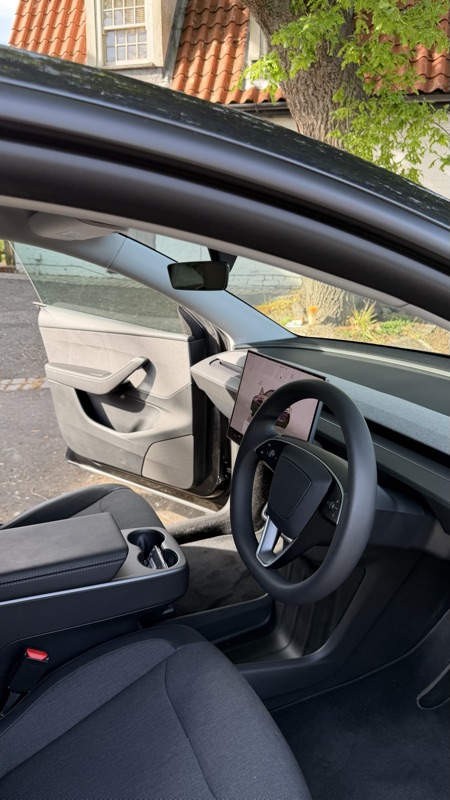 Open driver door showing cabin and steering wheel