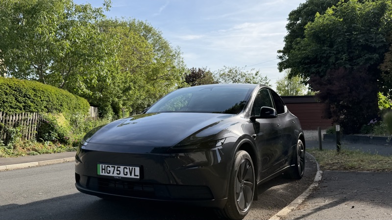 Wide front three-quarter view, road and hedge
